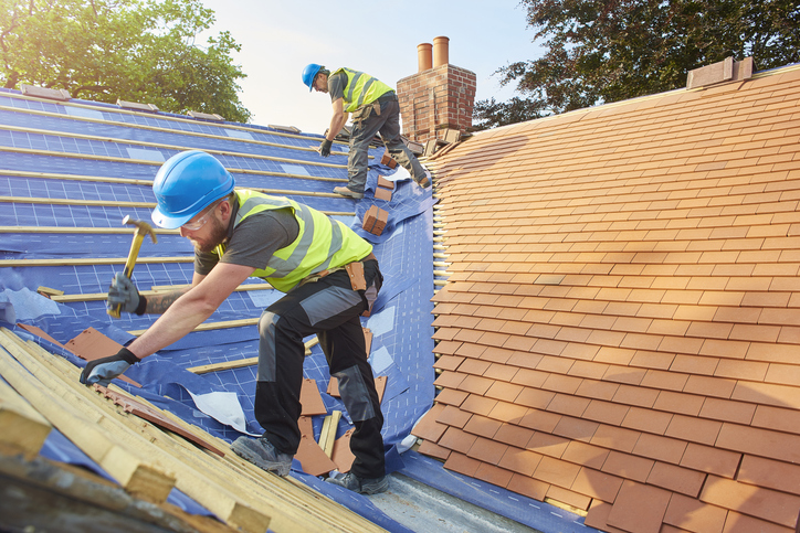 ROOFER NAILS ON A ROOF